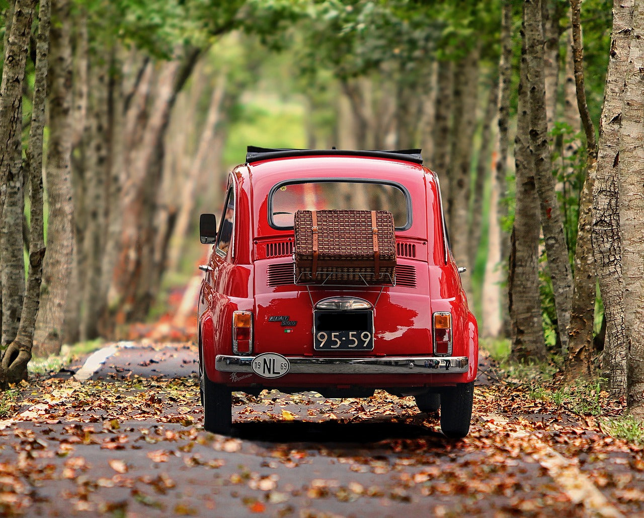 image of traveling red fiat 500