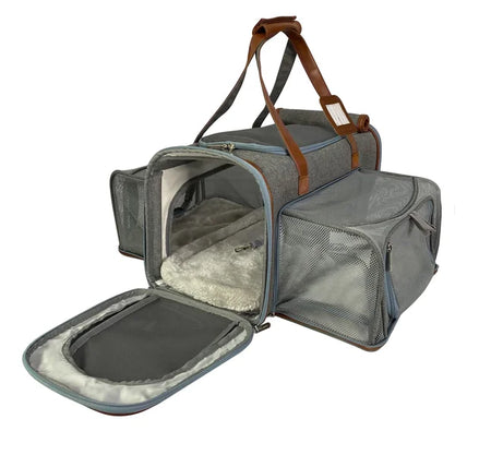 Gray pet carrier with open door on a white background