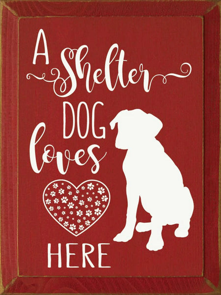 "A Shelter Dog Lives Here" Rustic Wood Home Decor Sign – 9" x 12" – Sawdust City red