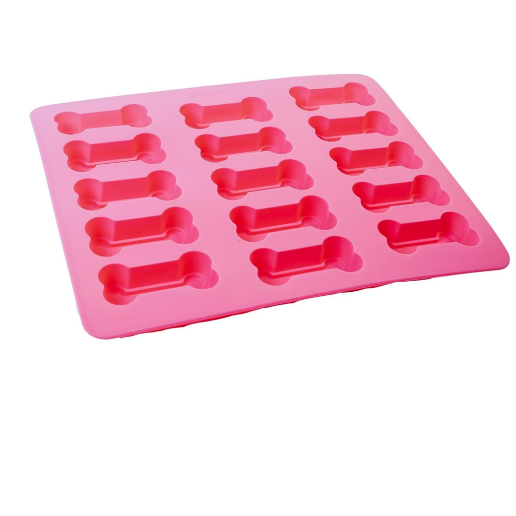 Pink silicone mold with bone-shaped cavities on a white background