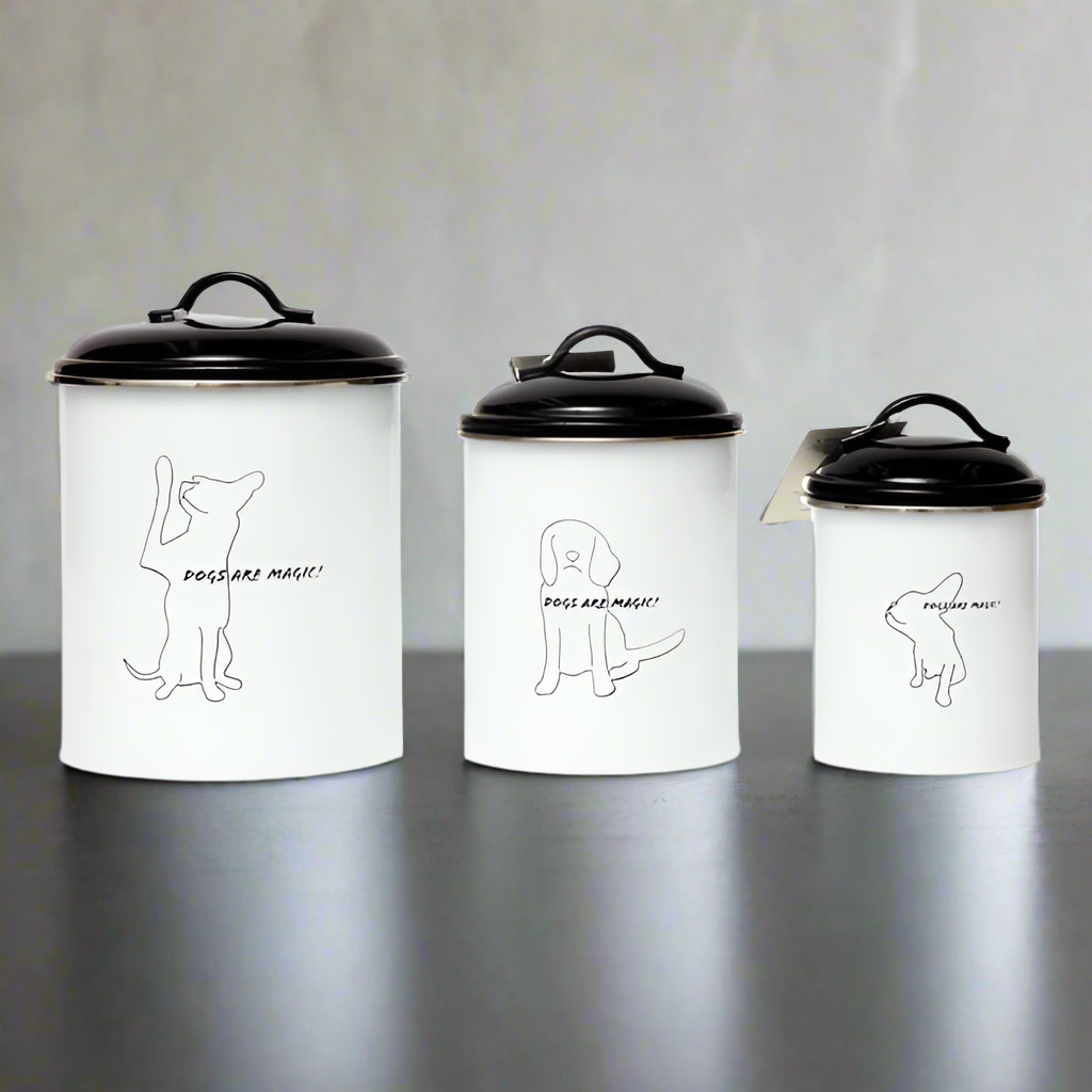 Three white canisters with black lids and dog illustrations on a gray surface.