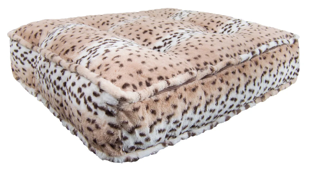 Leopard print pet bed on a white background