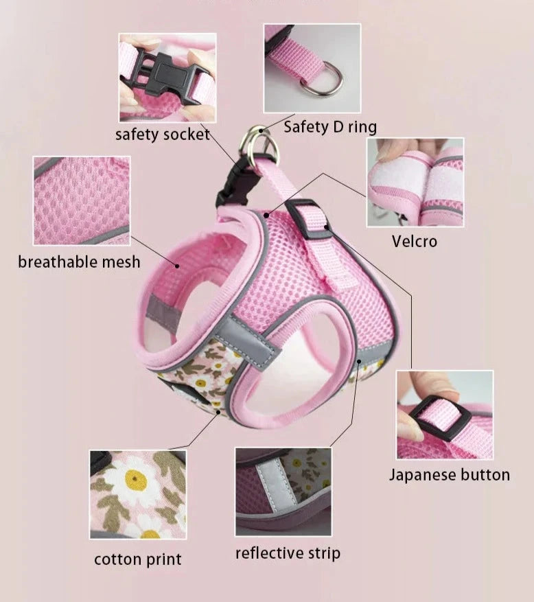 A pink floral-patterned pet harness for small dogs with various features, including a safety socket, safety D ring, breathable nylon mesh, Velcro strap, Japanese button, cotton print, and reflective strip. Individual close-ups of these elements are shown surrounding the main image of the Breathable Nylon Mesh Harness & Leash Set - Perfect Comfort & Control for Small Dogs & Puppies.