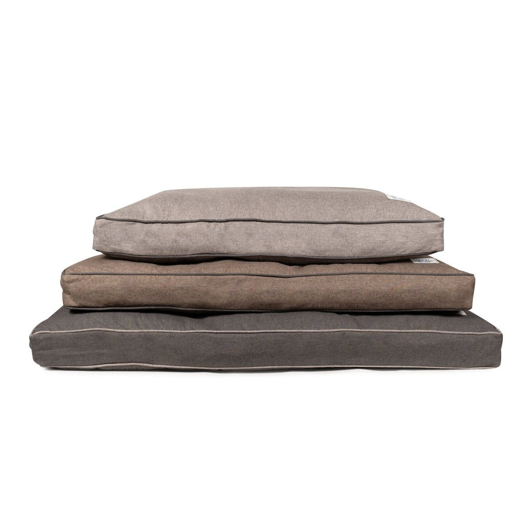 Stack of three brown pet beds on a white background