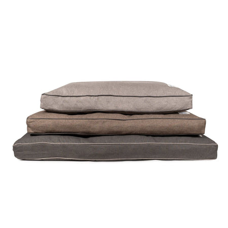 Stack of three brown pet beds on a white background
