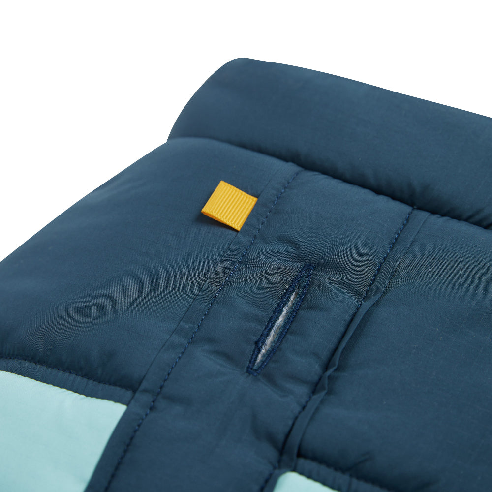 Close-up of a blue quilted product with a yellow tag on a white background