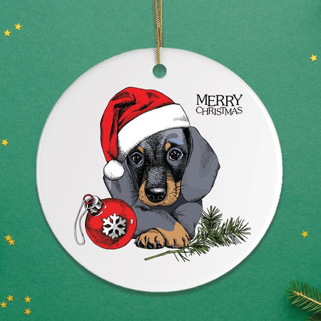 Christmas ornament with a dachshund wearing a Santa hat and holding a red ornament on a green background.