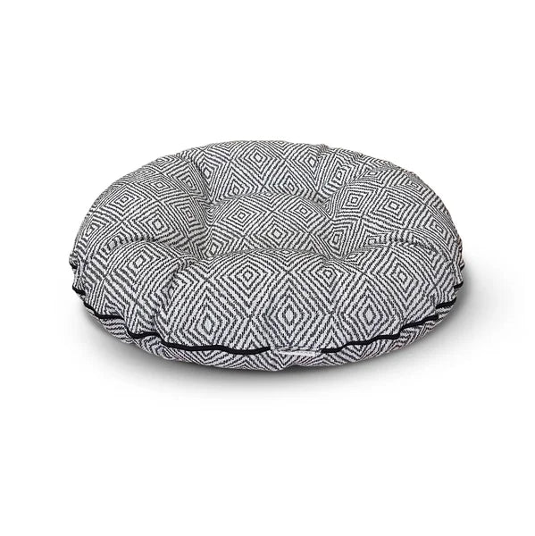 Round patterned pet bed on a white background