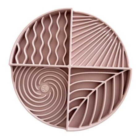 Pink silicone mat with geometric patterns on a white background