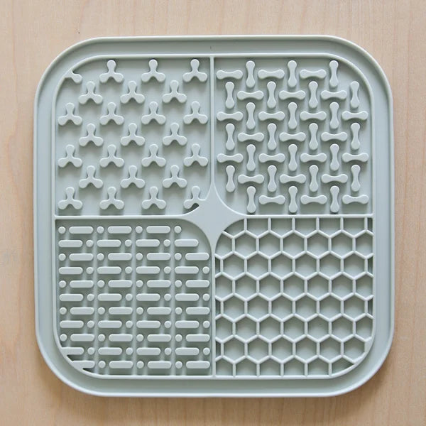 Gray silicone mat with various patterns on a beige background