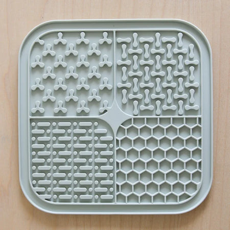 Gray silicone mat with various patterns on a beige background