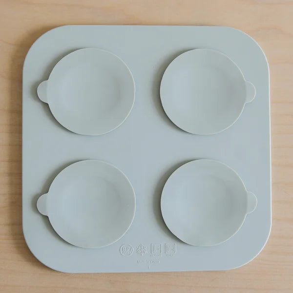 Silicone mold with four round cavities on a wooden surface