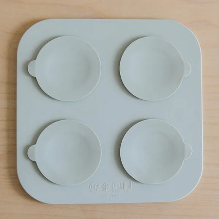 Silicone mold with four round cavities on a wooden surface