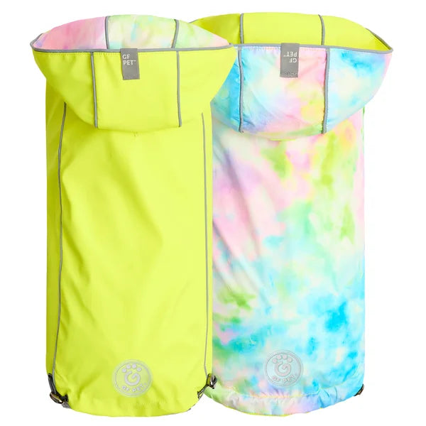 Two dog raincoats, one bright yellow and the other with a tie-dye pattern, on a white background.