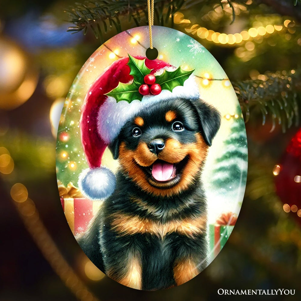 Christmas ornament with a Rottweiler puppy wearing a Santa hat on a decorated tree.