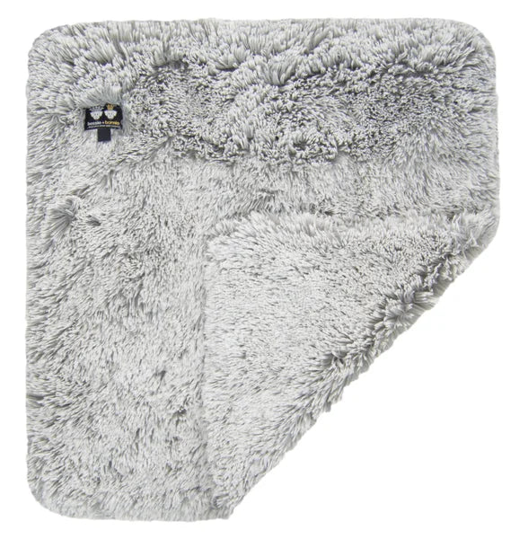 Fluffy gray blanket with a brand logo on a white background