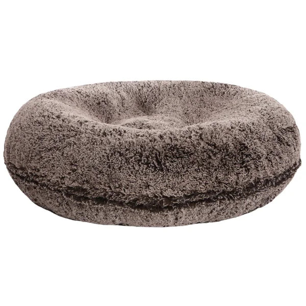 Round, plush pet bed on a white background