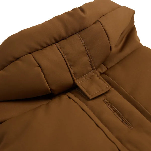 Close-up of a brown quilted jacket with a white background