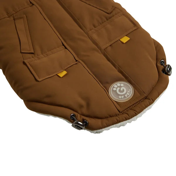 Brown pet vest with a visible brand logo on a white background