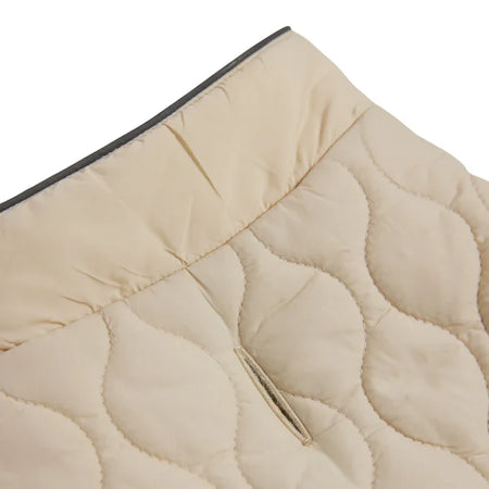 Close-up of a beige quilted fabric with a zipper on a white background