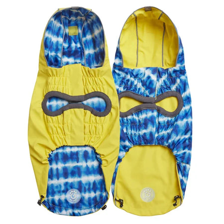 Yellow and blue tie-dye snow pants with goggles on a white background