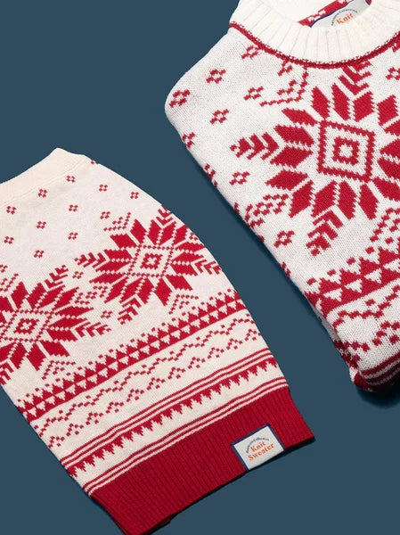Red and white patterned sweater and scarf on a dark blue background