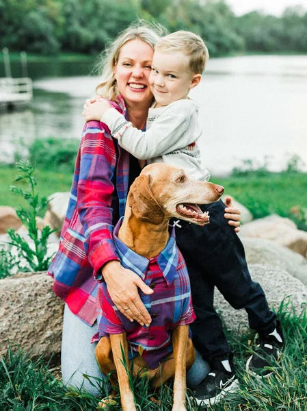Woman and child with a dog by a lake