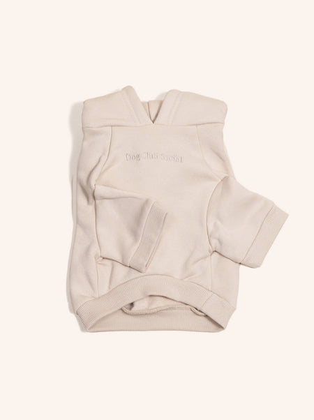 Beige baby carrier with 'One Small Step' branding on a white background