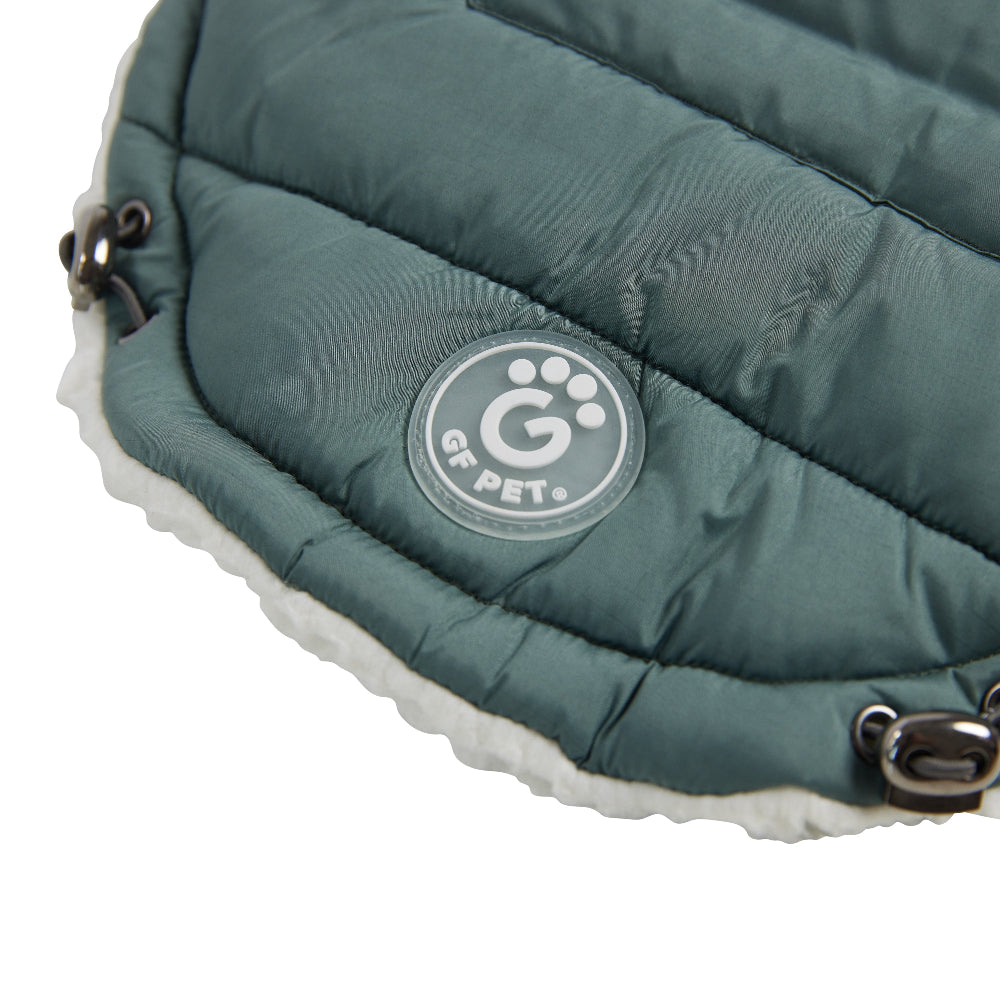 Green quilted pet coat with a visible brand logo on a white background
