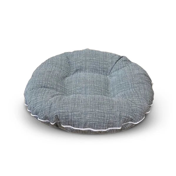 Round gray cushion with white trim on a white background