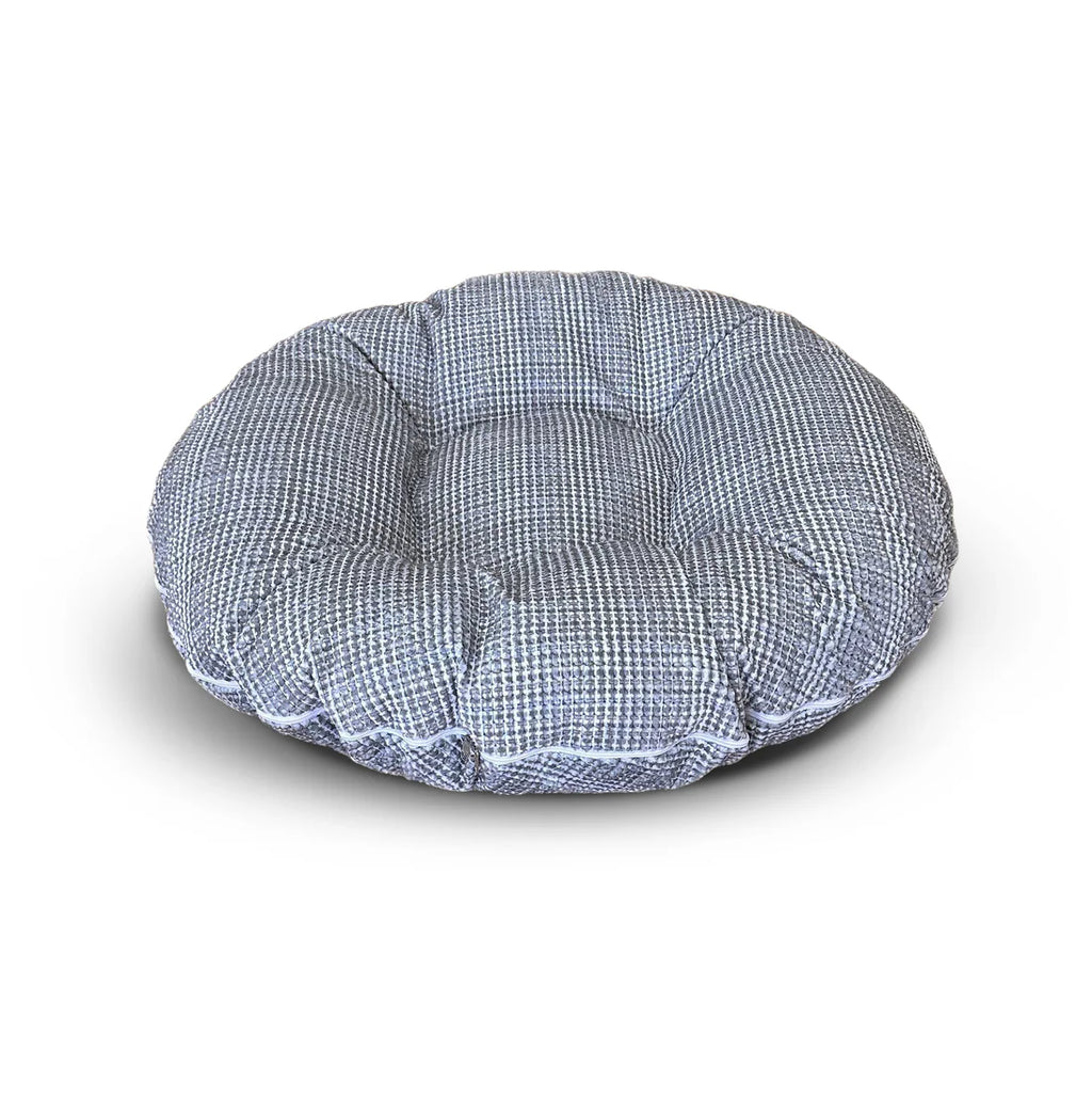 Round pet bed with blue checkered pattern on a white background