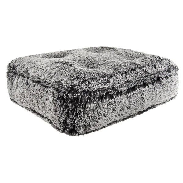 Folded gray fluffy blanket on a white background