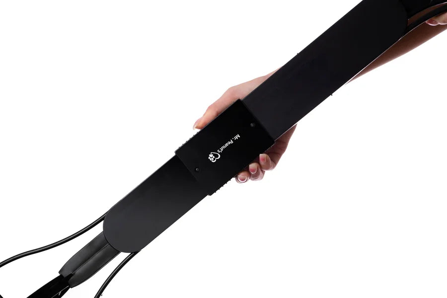 Black electronic device held by a hand on a white background