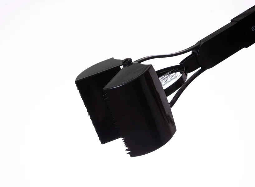 Close-up of a black metal tool with a white background