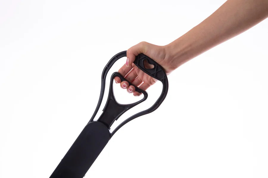 Hand holding a black resistance band against a white background