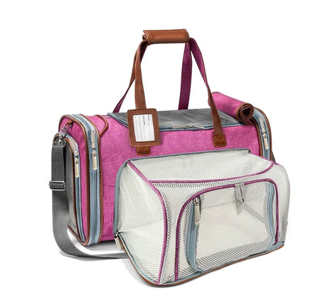 Pink pet carrier with a transparent front section on a white background