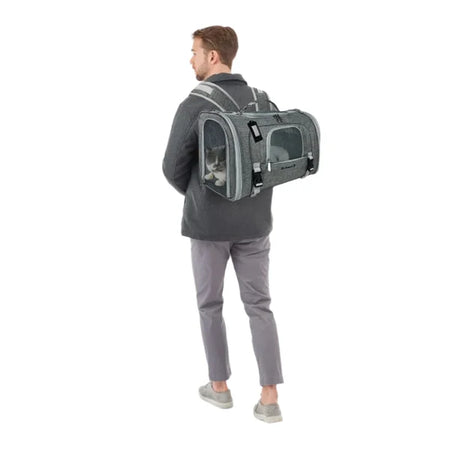 Person wearing a gray pet carrier on a white background