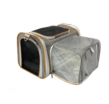 Pet carrier with mesh side and black interior on a white background