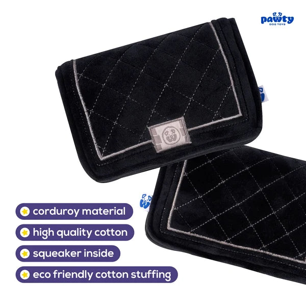 Black quilted pet toy with a label on a white background, featuring text about material and features.