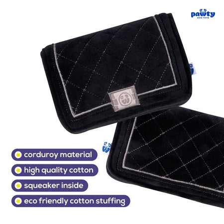 Black quilted pet toy with a label on a white background, featuring text about material and features.