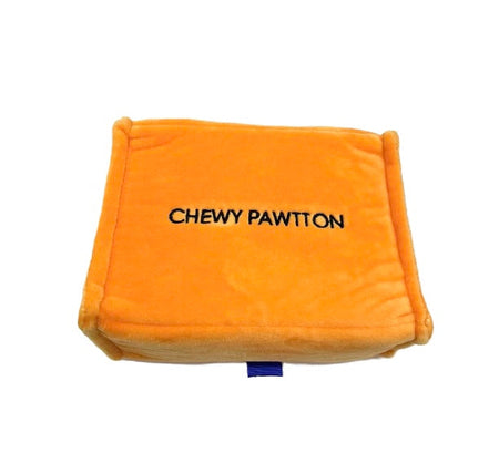 Orange pillow with 'CHEWY PAWTTON' text on a white background