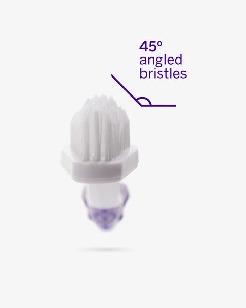 White scrubber with purple bristles on a white background, labeled '45° angled bristles'.