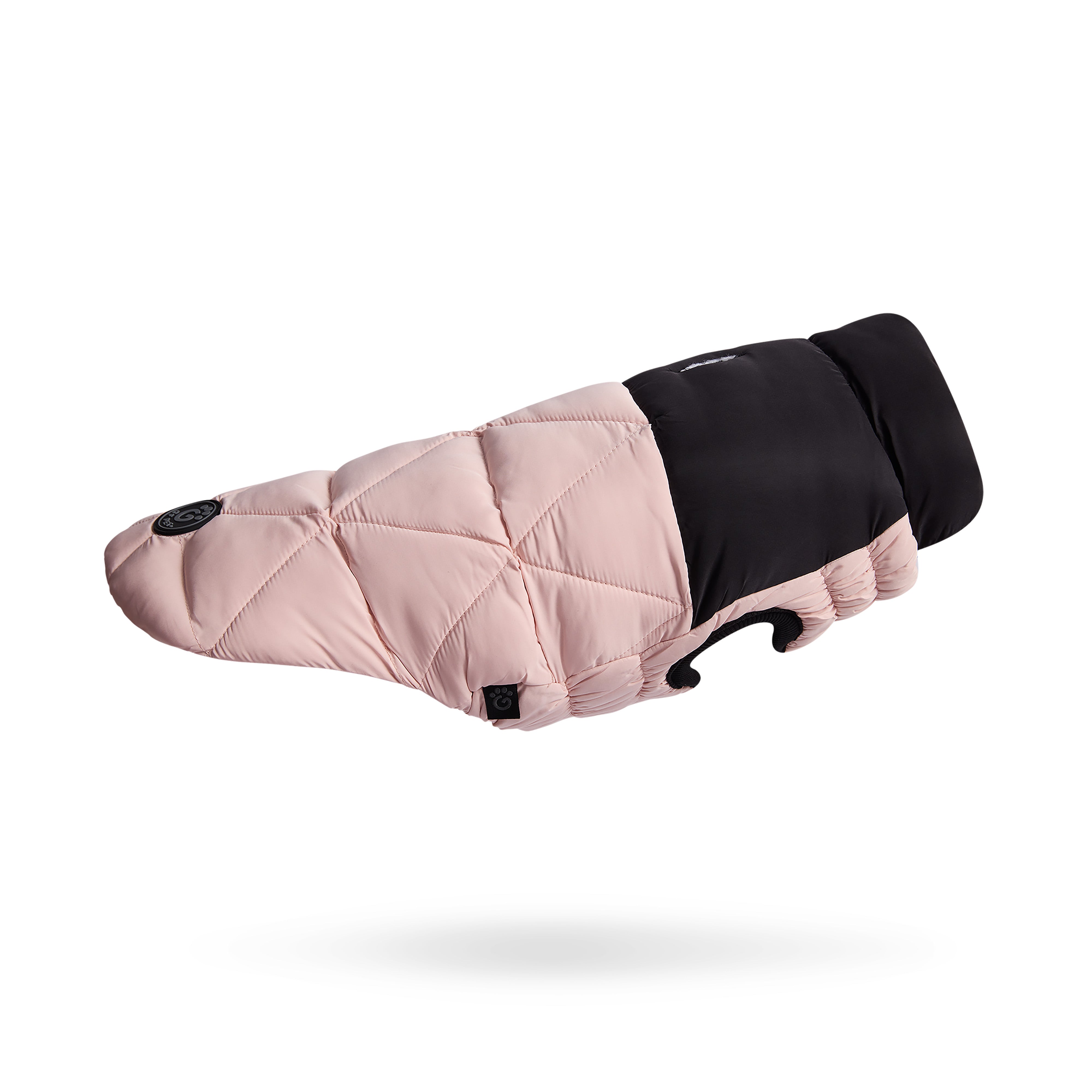 Pink quilted dog coat with black trim on a white background