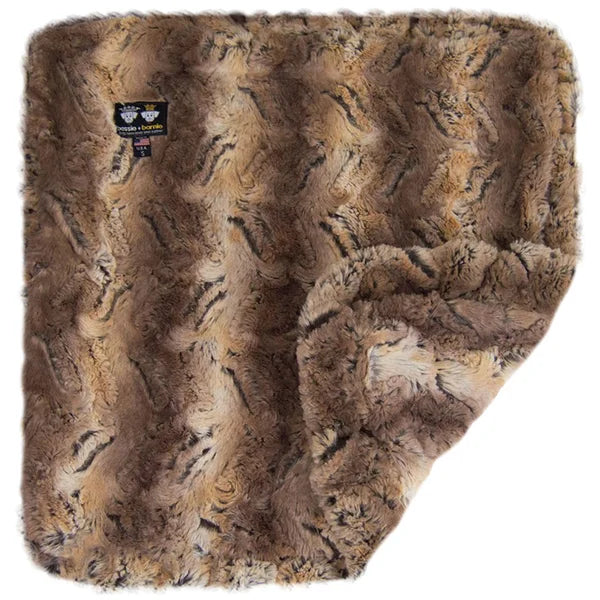 Brown faux fur blanket with a brand label on a white background