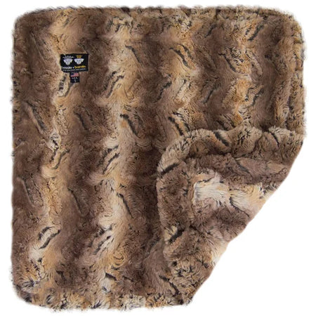 Brown faux fur blanket with a brand label on a white background