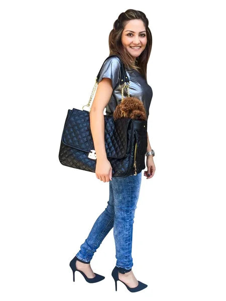 Woman holding a black quilted handbag with a white background