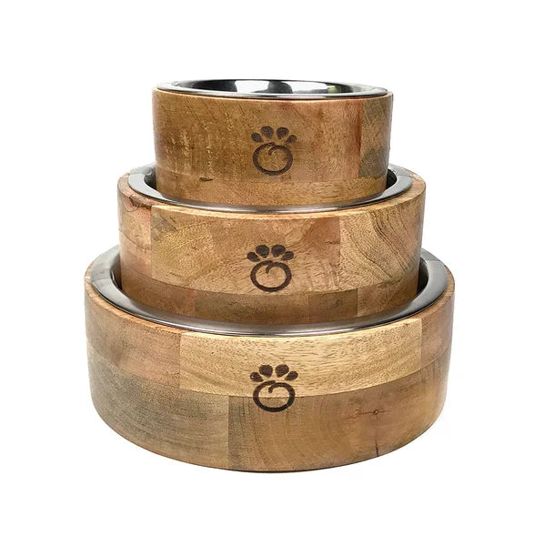 Set of three wooden pet bowls with paw print design on a white background