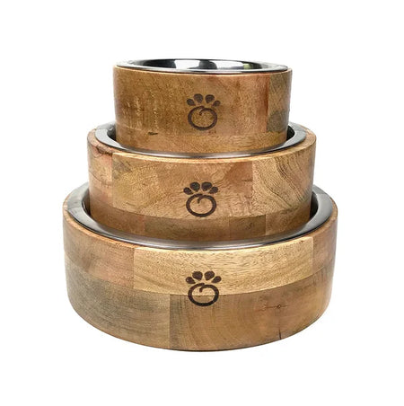Set of three wooden pet bowls with paw print design on a white background