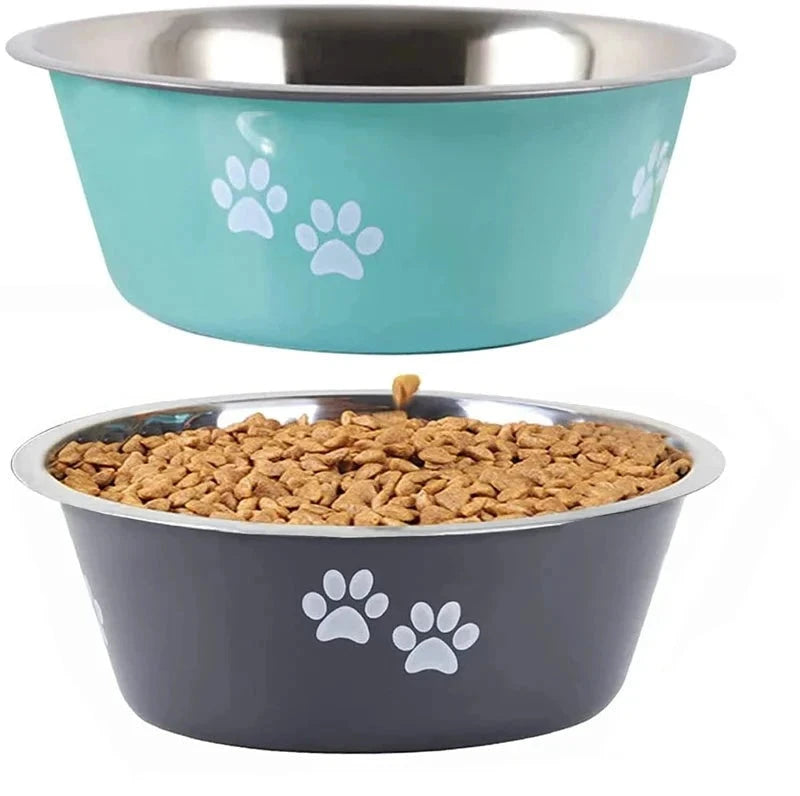 Two Premium Non-Slip Stainless Steel Dog Bowls - Perfect Feeder and Drinker for Small, Medium, and Large Dogs are shown. The top bowl is turquoise with white paw prints and is empty. The bottom bowl is gray with white paw prints and filled with dry kibble. Both Premium Non-Slip Stainless Steel Dog Bowls - Perfect Feeder and Drinker for Small, Medium, and Large Dogs feature a stainless steel interior and a non-slip base, as seen in the side view of one bowl's anti-skid rubber base displayed.