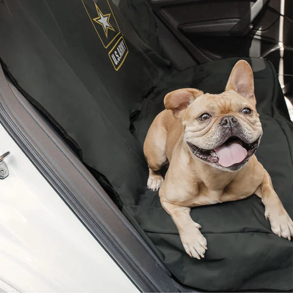 Dog sitting on a black car seat cover with U.S. Army logo